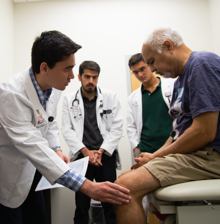 medical students working with a patient